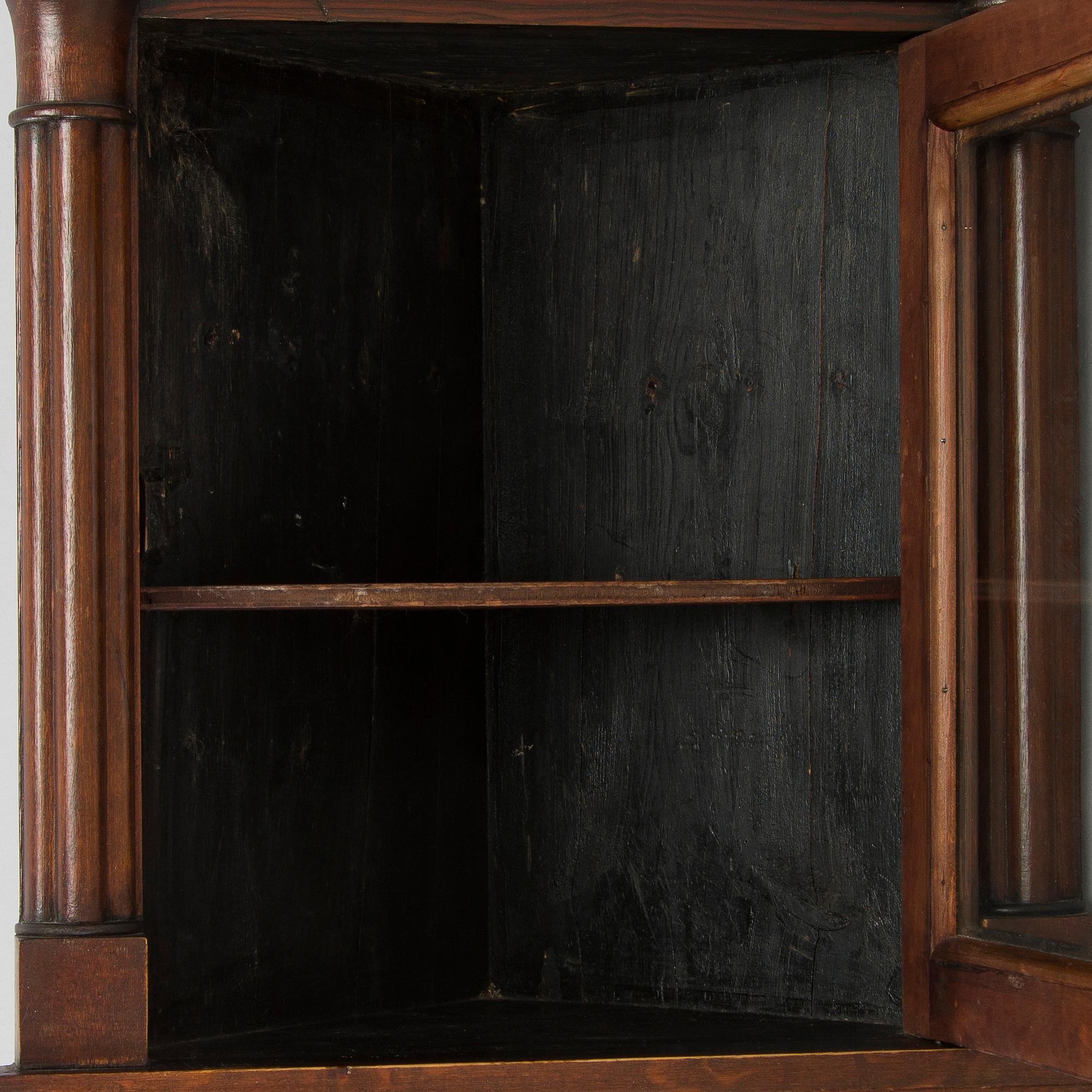 A mid-19th-century wall cabinet.