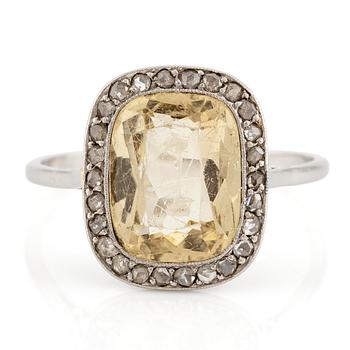 579. A ring in 18K white gold set with a yellow faceted tourmaline and rose-cut diamonds.