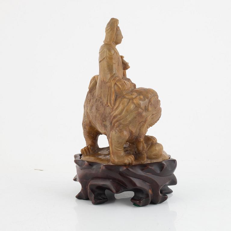 A soapstone guanyin with wooden stand, China, late Qing dynasty/early 20th century.
