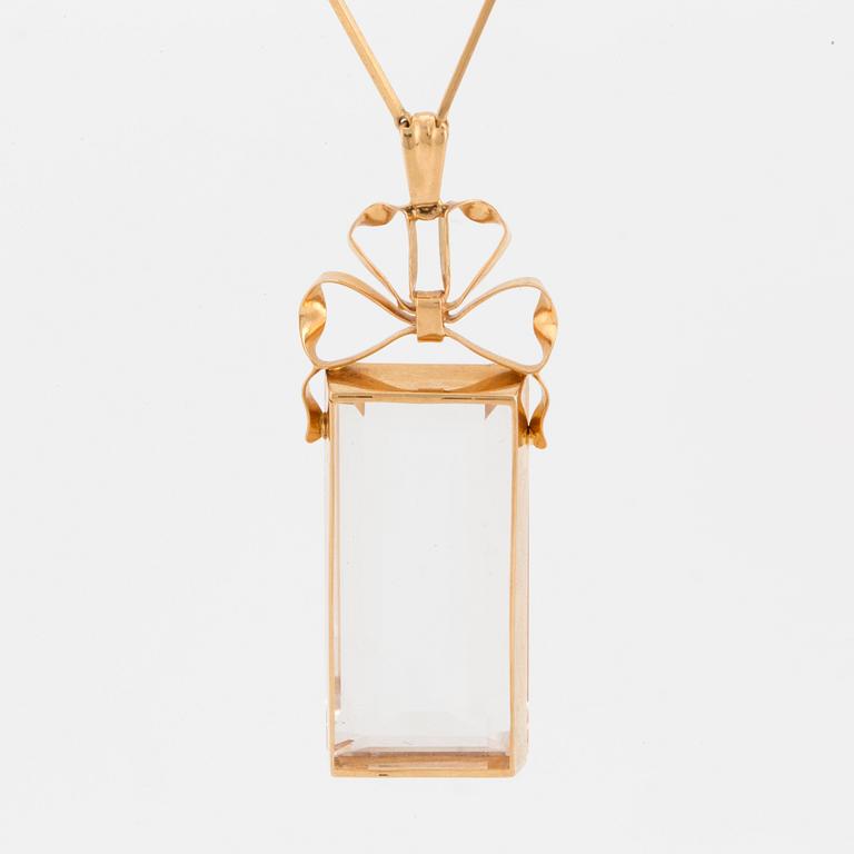 A chain and a pendant set with step-cut quartz.