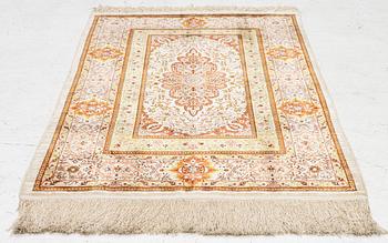 A Hereke silk rug, West Anatolia, c. 107 x 69 cm.