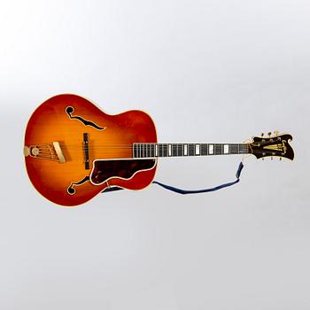 A Crafton Rex acoustic guitar.