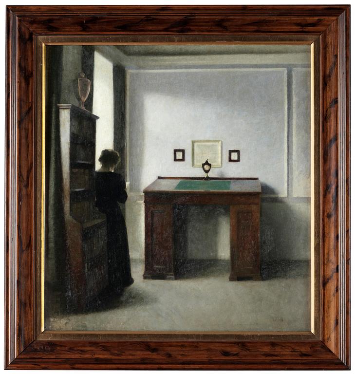 Vilhelm Hammershöi, A writing table and a young woman in an interior.