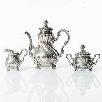 A Norwegian silver Rococo style coffee pot, cream jug, and sugar bowl, Norsk Filigransfabrikk, Oslo circa 1920.