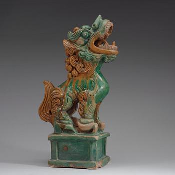 A green and yellow glazed pottery figure of a buddhist lion, presumably Ming dynasty.