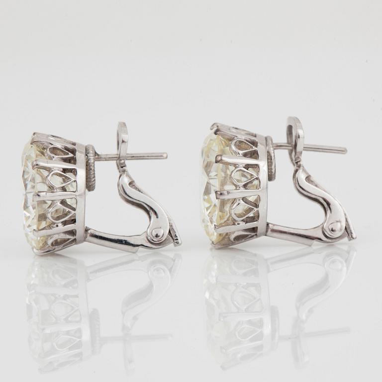 A pair of brilliant-cut diamond stud earrings. Total carat weight 14.24 cts.