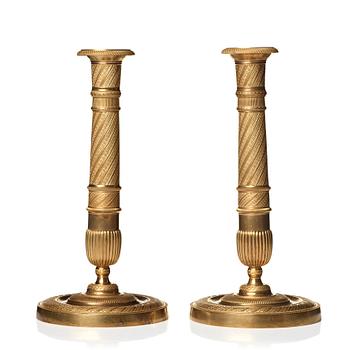 121. A pair of Empire candlesticks.