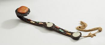 A hardwood Ruyi Sceptre with inlays of nephrite, turquoise, coral and other materials. Qing dynasty, presumably Qianlong.