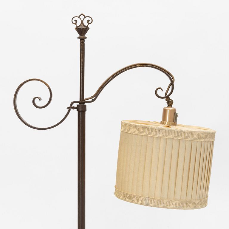 An iron floor lamp, early 20th Century.