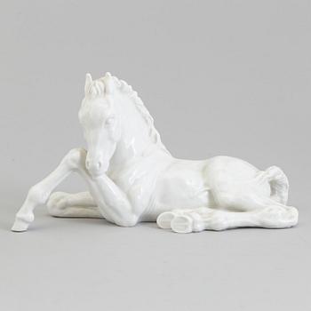 A white glazed porcelain figure of a reclining foal, Meissen, 1950's.