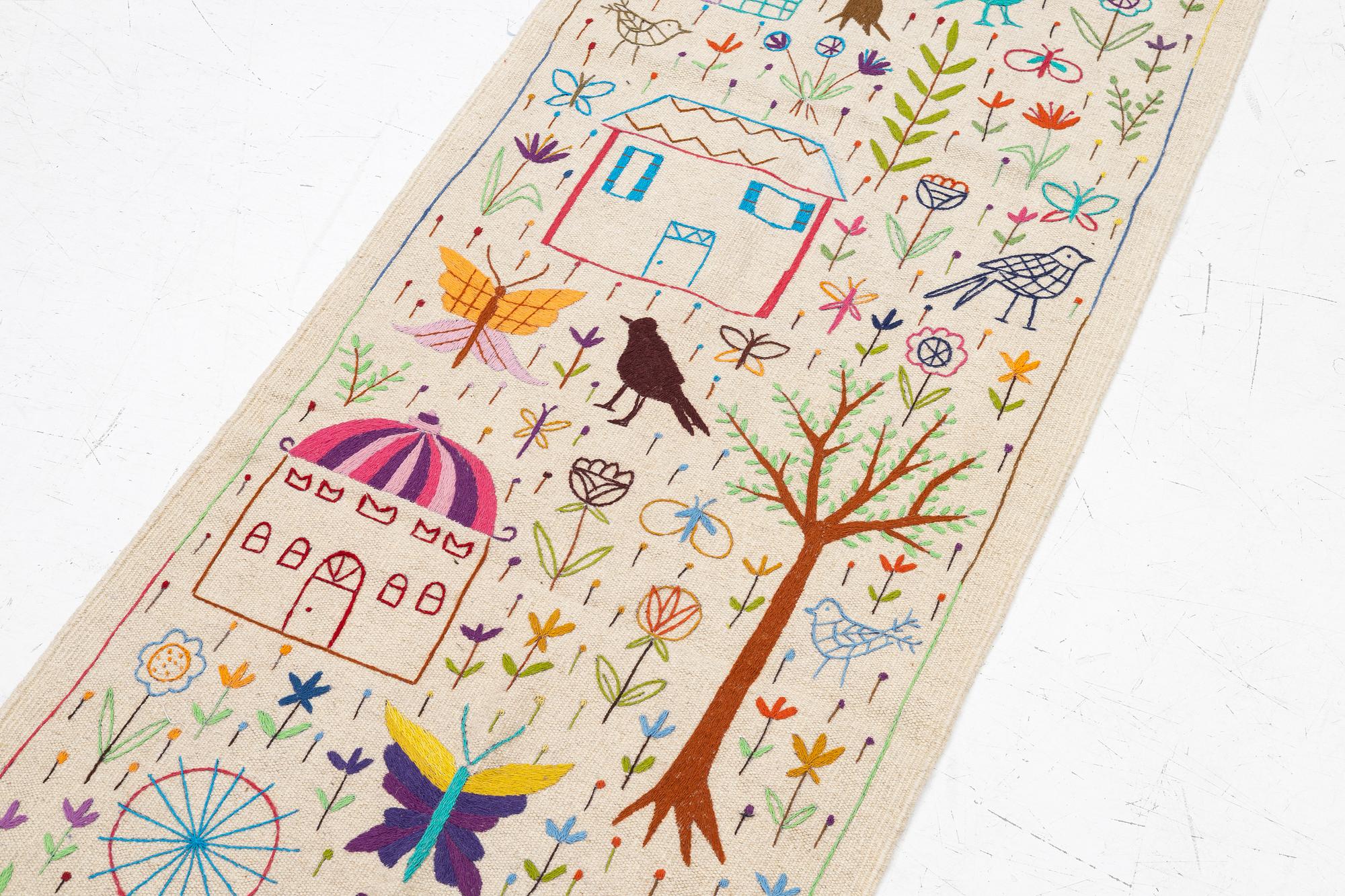 A hand-embroidered Kelim runner, c. 292 x 85 cm.