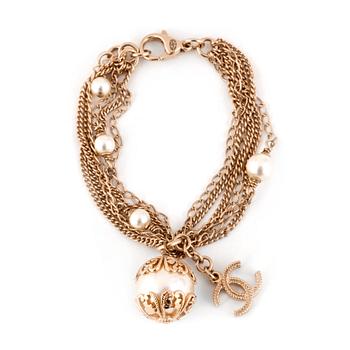 723. CHANEL, a silvertinted bracelet with white decorative pearls.