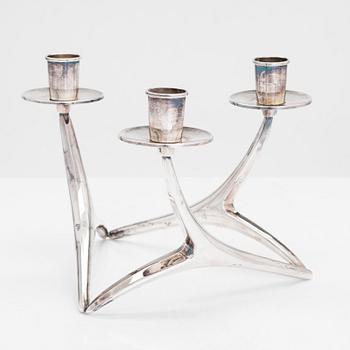 Anna-Greta Eker, a three-armed silver candelabrum, Auran Kultaseppä Oy, Turku, Finland 1995.