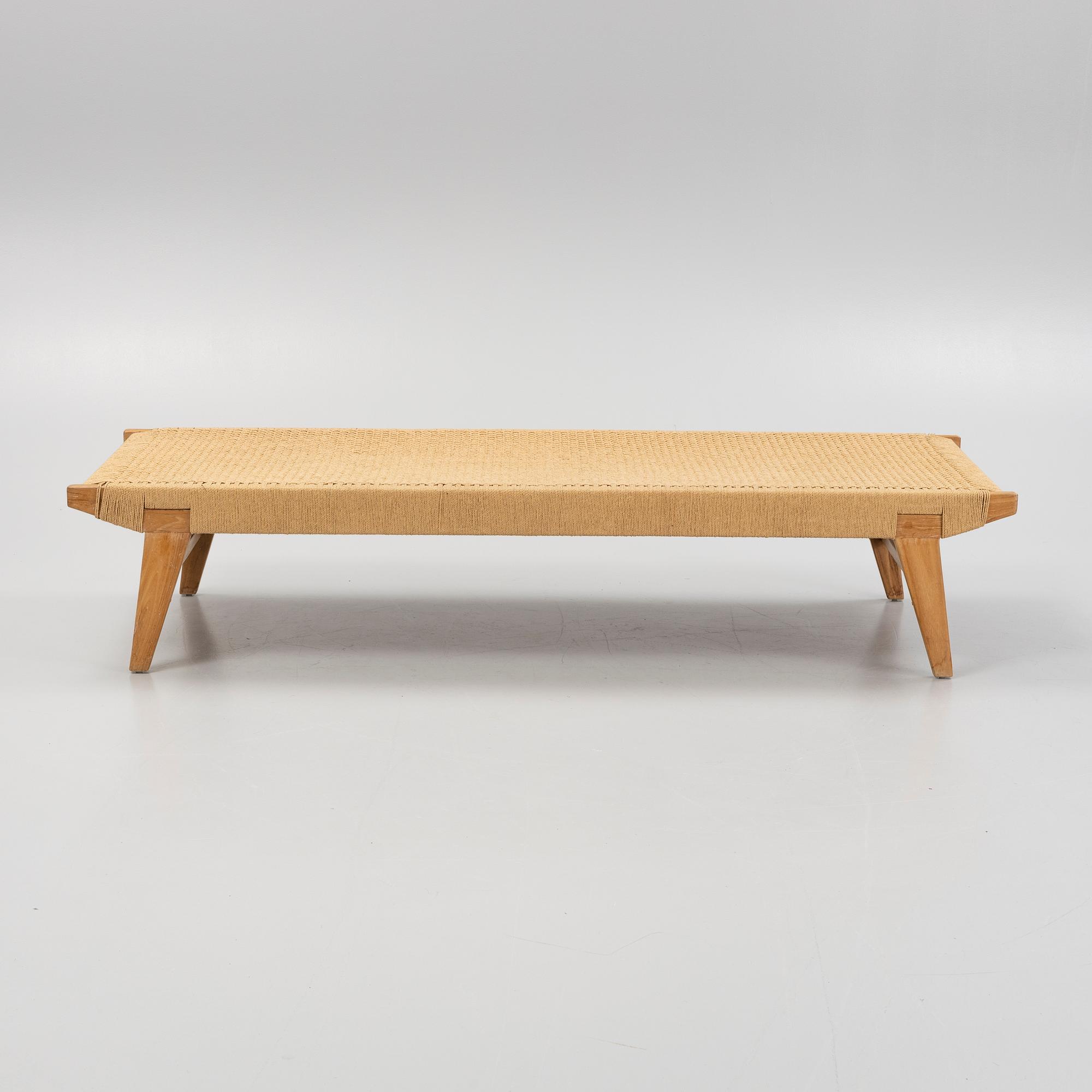 A contemporary teak daybed.