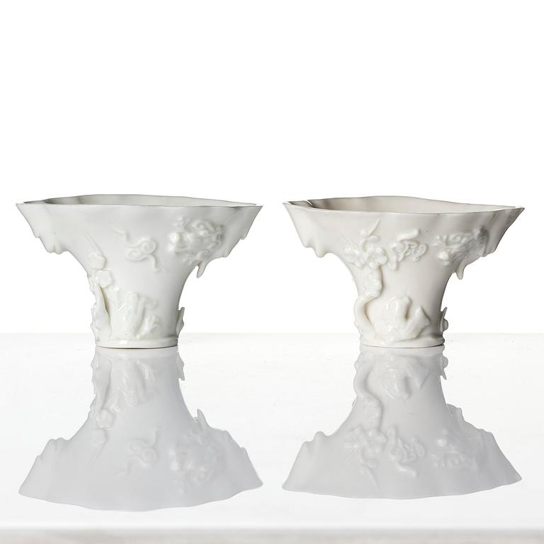 A pair of blanc de chine rhinoceros libation cups, Qing dynasty, Kangxi (1662-1722).