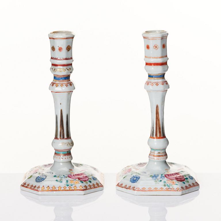 A pair of famille rose candles sticks, Qing dynasty, Qianlong (1736-95).