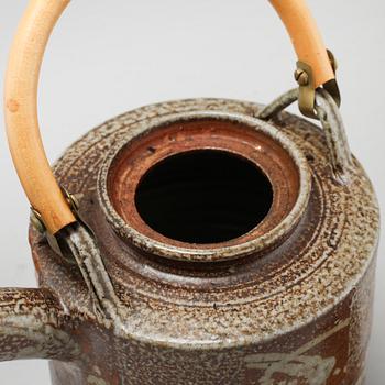 A tea pot and three tea cups in saltglazed stoneware by Christer Sjöblom, signed tea pot.