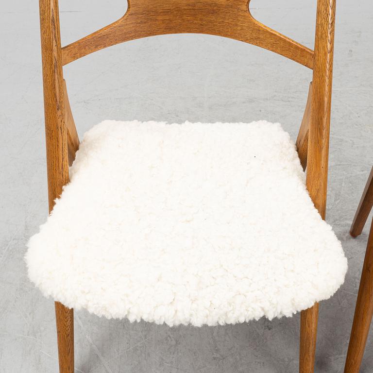 A set of six model CH 29 oak chairs by Hans J Wegner, two with leather upholstery and four with sheepskin.