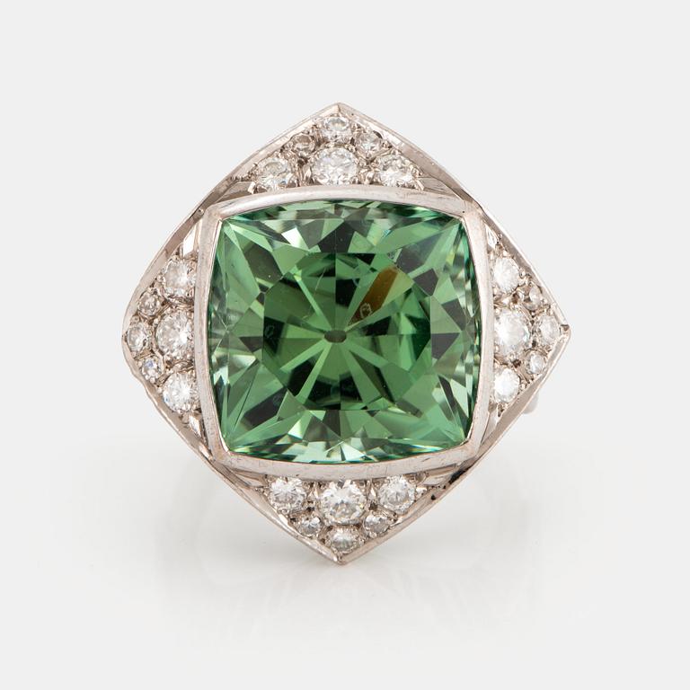 An 18K white gold ring set with a faceted tourmaline and round brilliant- and eight-cut diamonds.
