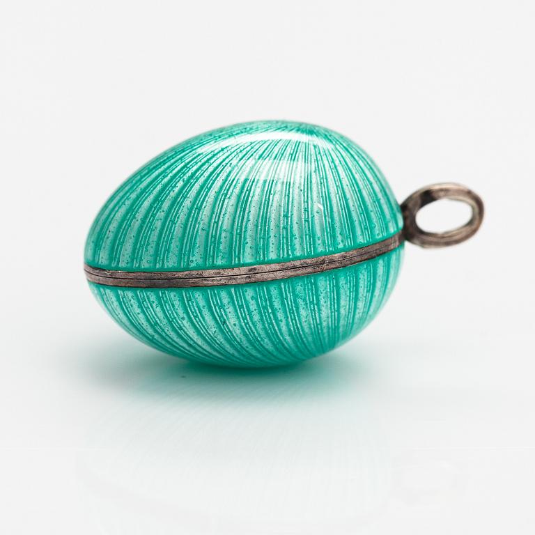 An egg shaped pendant made of silver and enamel. Tillander, Helsinki.