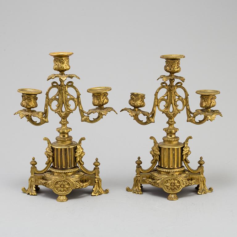 A table CLOCK and a pair of candelabra, second part of 19th century.