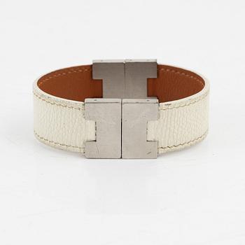Hermès, a white leather bracelet.