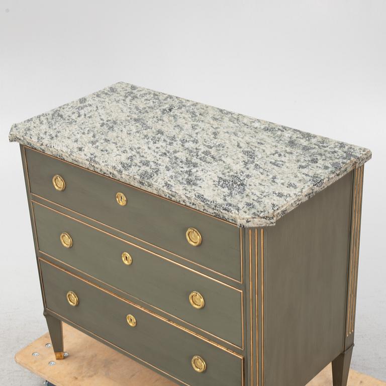 A painted Gustavians style chest of drawers with stone top, first part of the 20th Century.