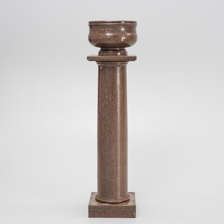 A limestone pedestal from around the year 1900.