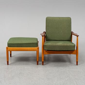 A 1950's beech and teak model FD 161 easy chair with stool by Arne Vodder for France & Son.