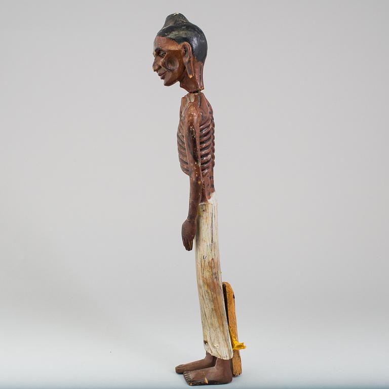 A wooden sculpture of a indian man, early 20th Century.
