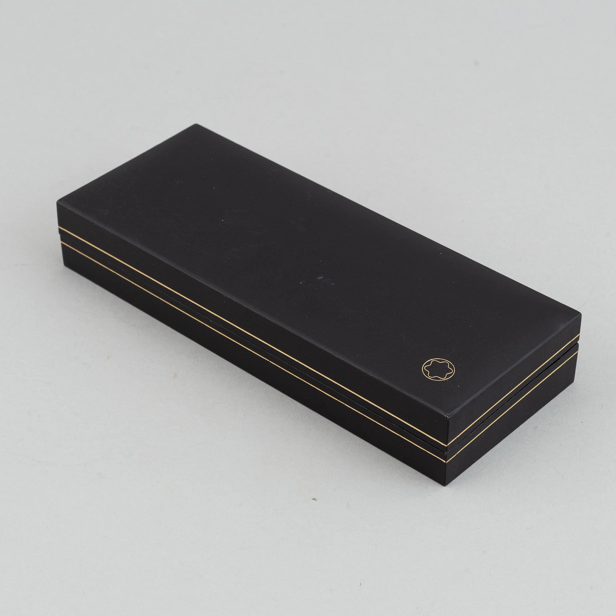 MOntblanc, a ball point pen and leather passport holder.