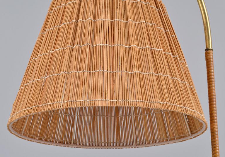 Paavo Tynell, PAAVO TYNELL (FINLAND), A FLOOR LAMP. brass. Rattan covered pole and shade made of splints. Oy Taito Ab.
