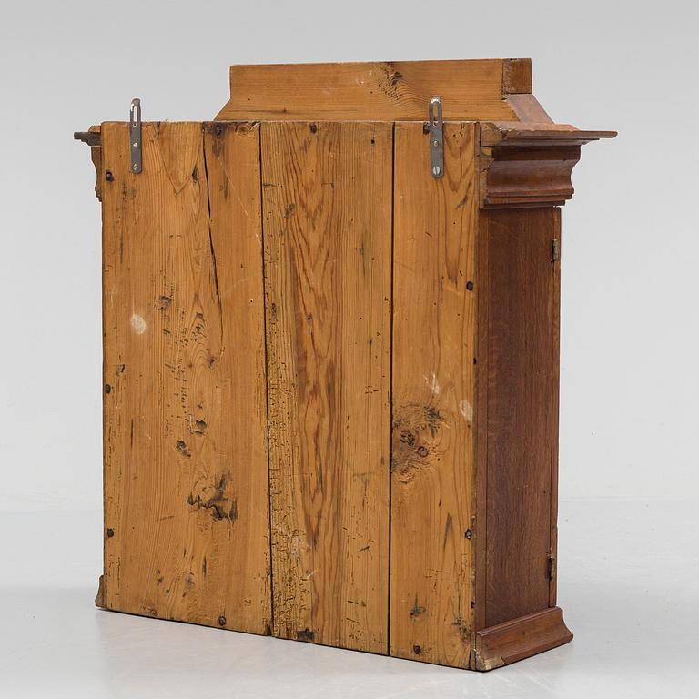 A 118/19th century wall mounted oak cupboard.