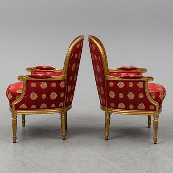 A pair of Louis XVI-style armchairs.