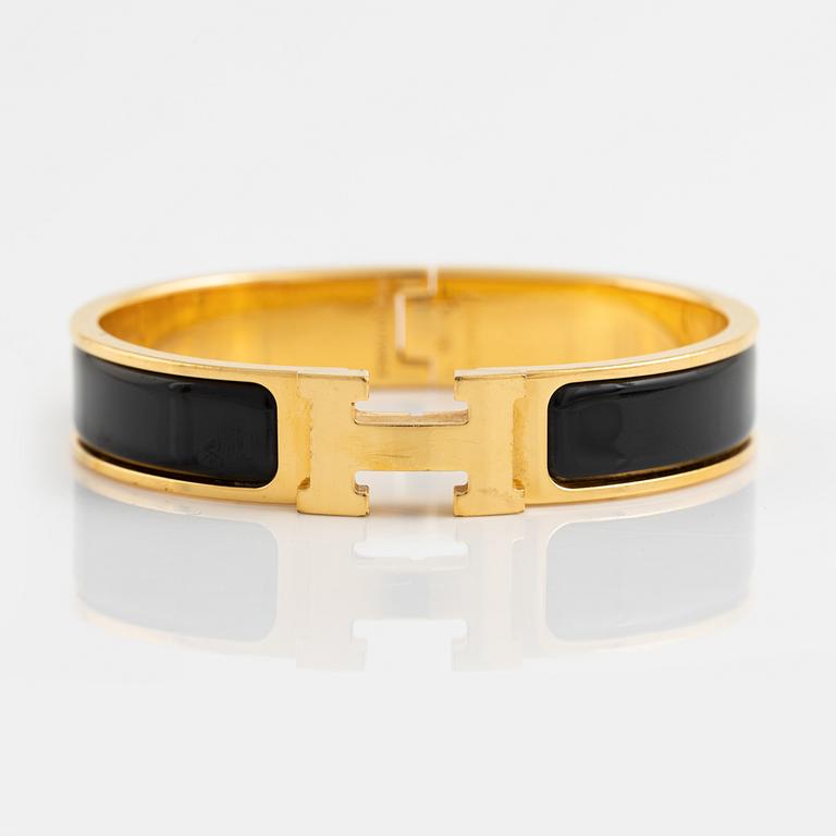 Hermès, a 'Clic H' bracelet.