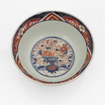 A Chinese dinner plate and a Japanese imari bowl, 18th Century together with a Chinese 19th Century jar with cover.