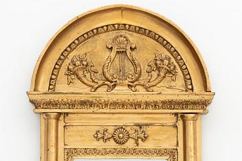An Empire mirror, early 19th Century.