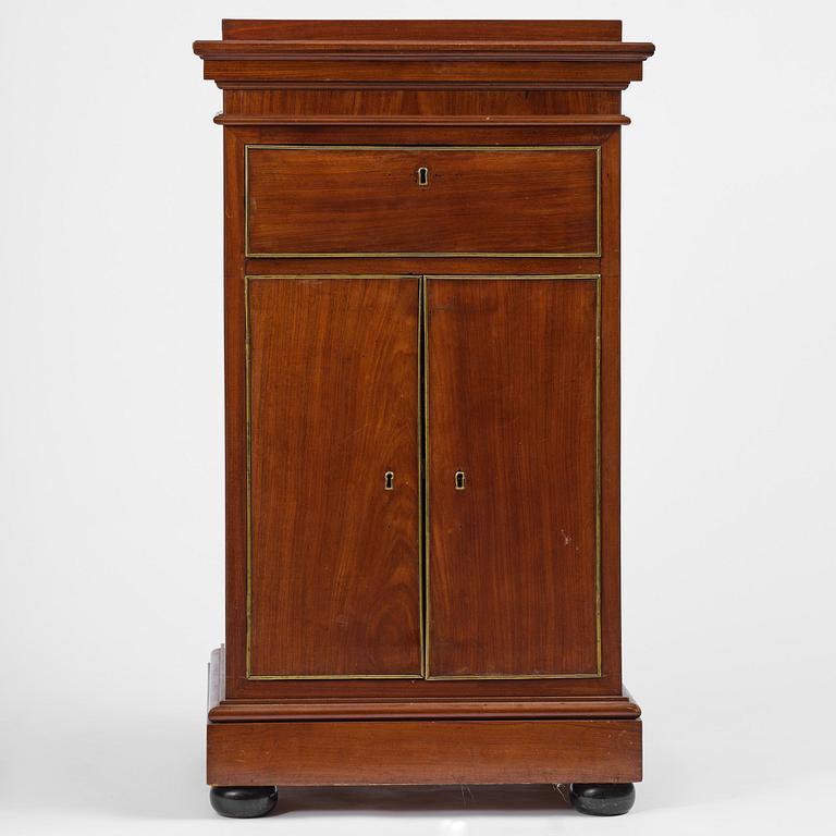 A late Gustavian mahogany column-cabinet, Stockholm, circa 1800.
