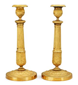 626. A pair of French Empire early 19th Century candlesticks.
