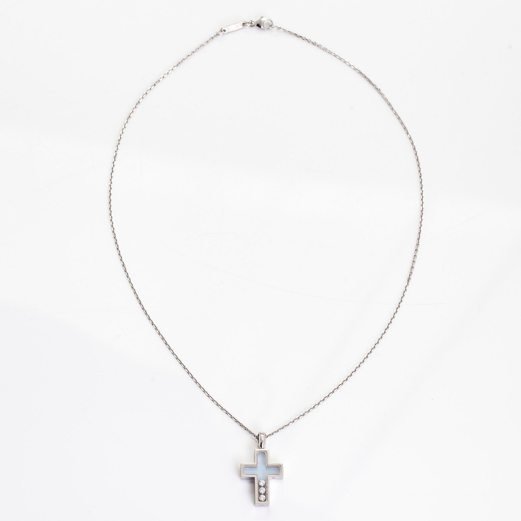 Chopard, an 18K whitegold 'Happy Diamonds" cross necklace set with diamonds.