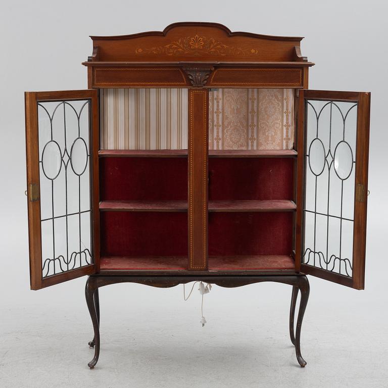 A display cabinet, England, early 20th century.