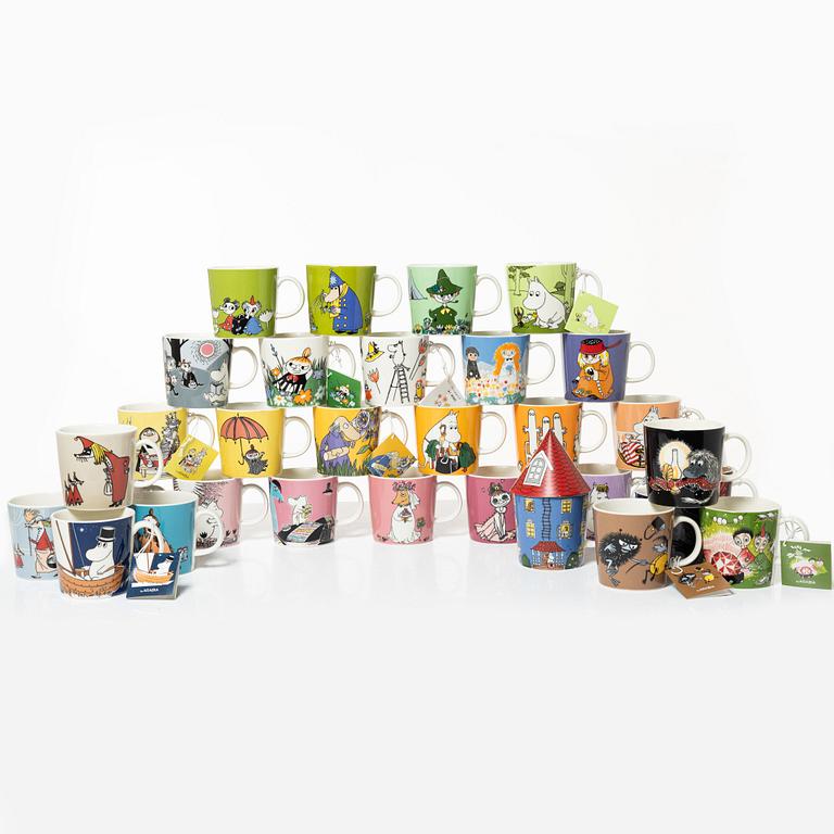 A set of 31 Moomin mugs, Arabia, Finland.