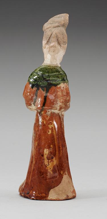 A green and yellow glazed figure of a standing lady, Tang dynasty.