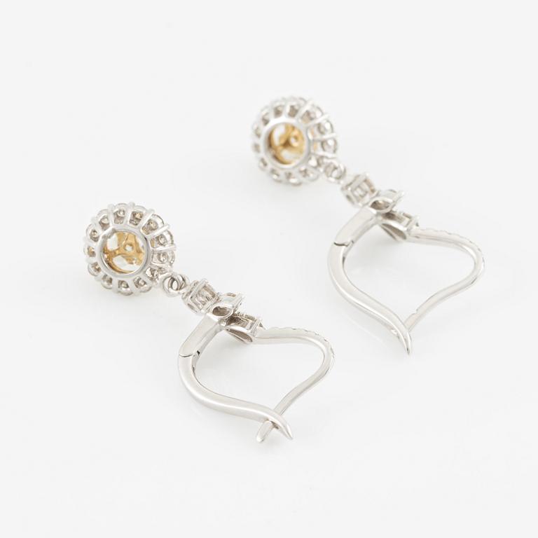 Earrings, 18K white gold set with round brilliant and yellow marquise-cut diamonds.
