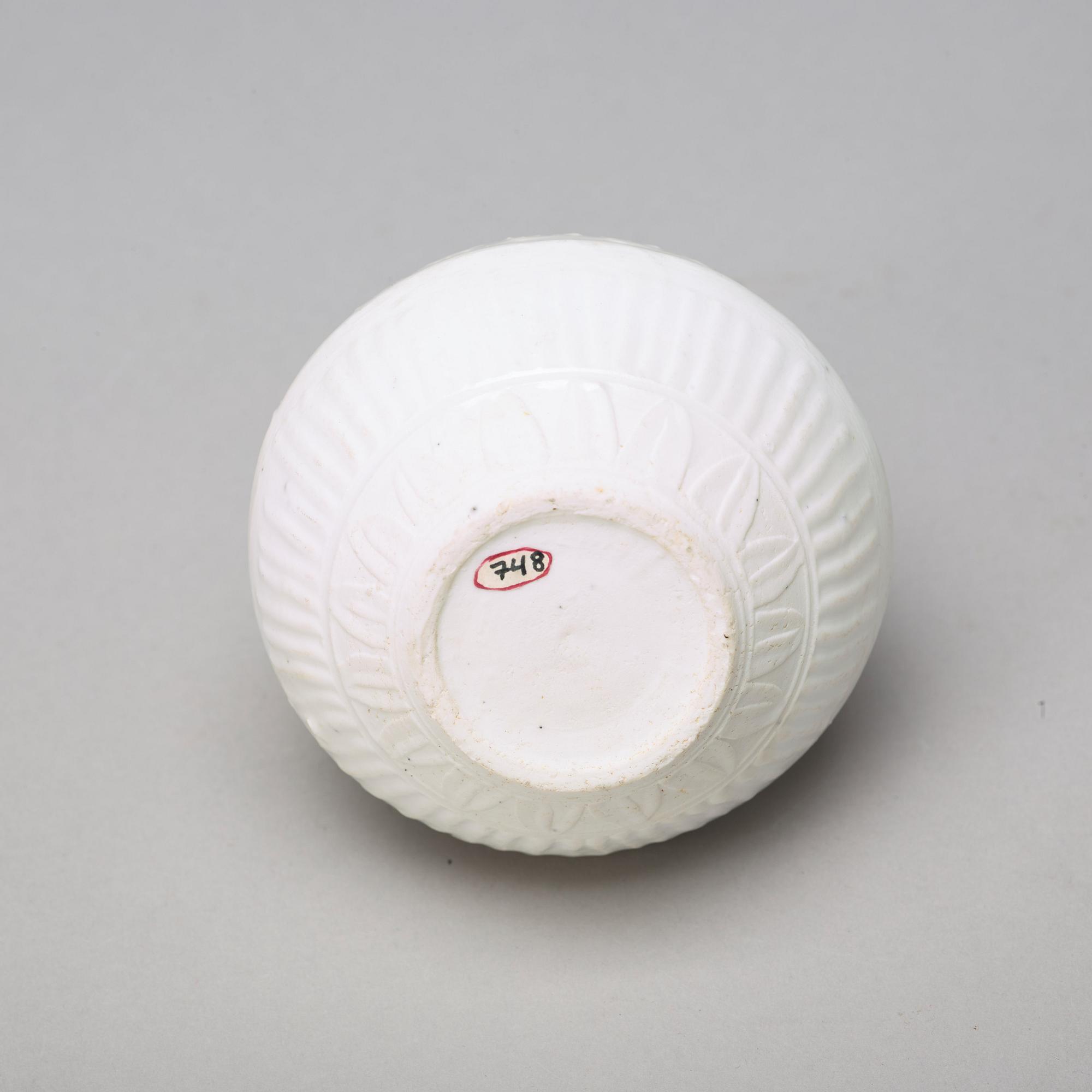 Two celadon glazed dishes and a white glazed jar, South East Asia, presumably 12th/17th Century.