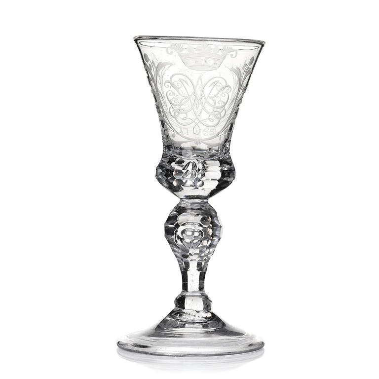 A cut and engraved glass goblet, dated 1755.