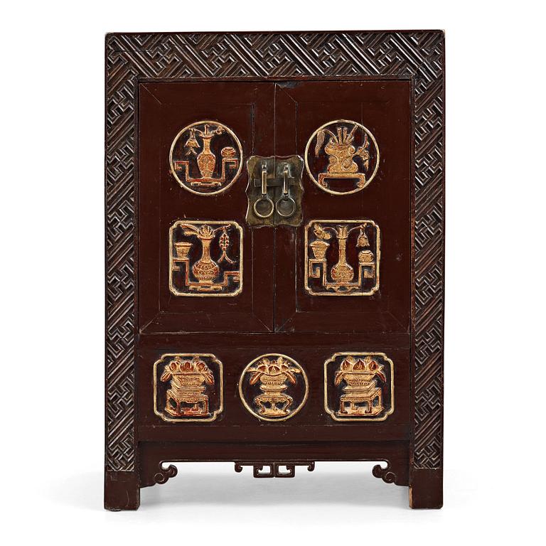 A carved and gilt wooden cabinet, Qing dynasty (1664-1912).