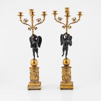 A pair of Empire-style ormolu and marble four-light candelabra, late 19th century.