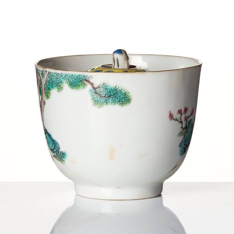 A famille rose 'trick cup' with a little figure, Qing dynasty, 19th Century.