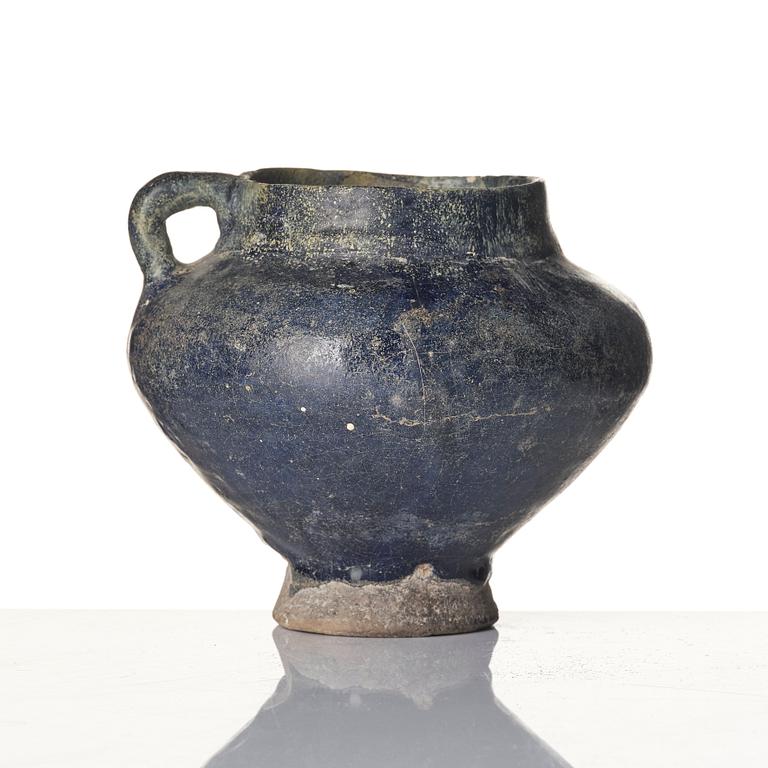 A blue-glazed Nishapur pottery Jug, Persia, 13th century.